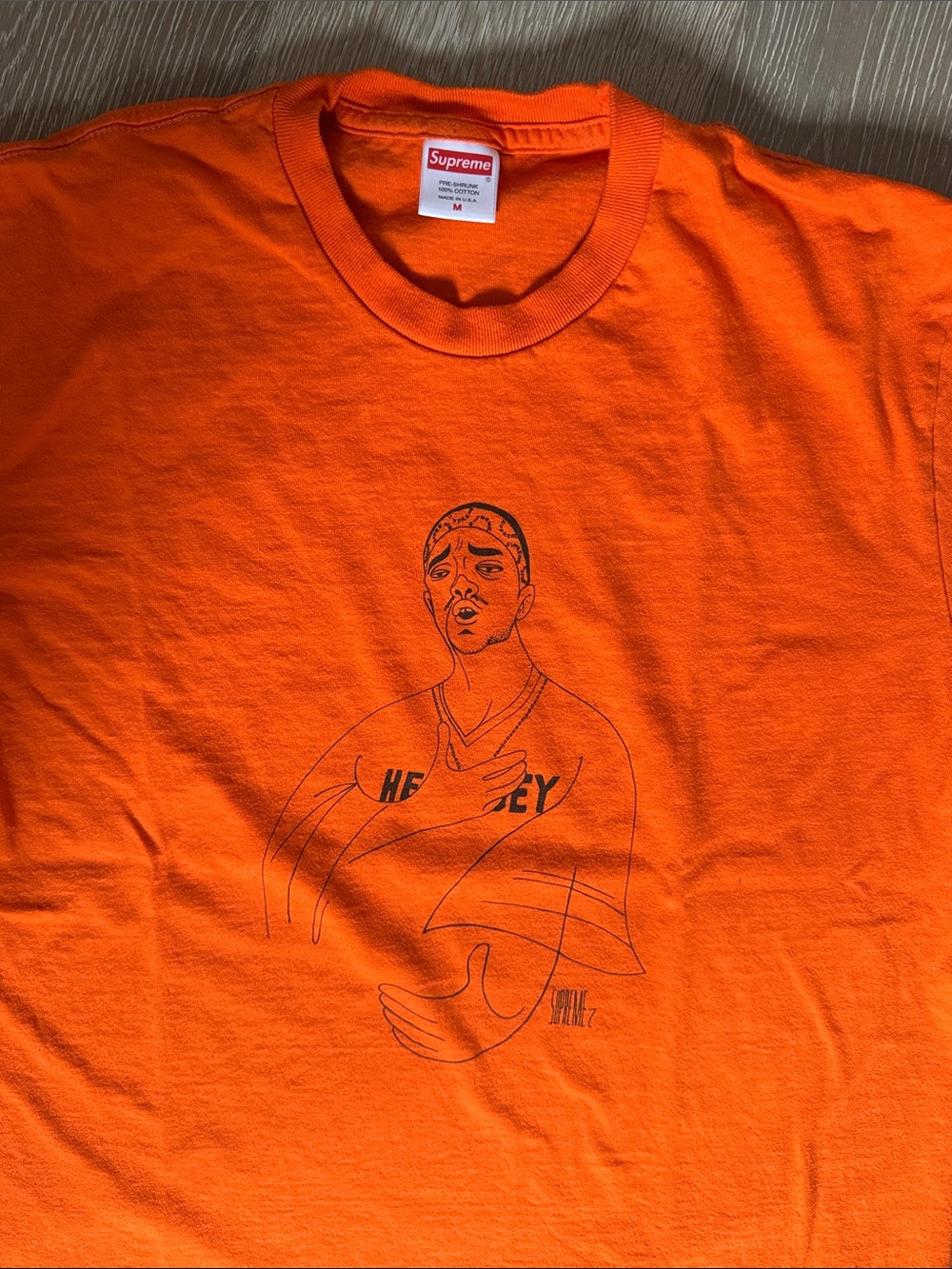 Supreme Orange Short Sleeve Tee with Black Line Portrait Graphic